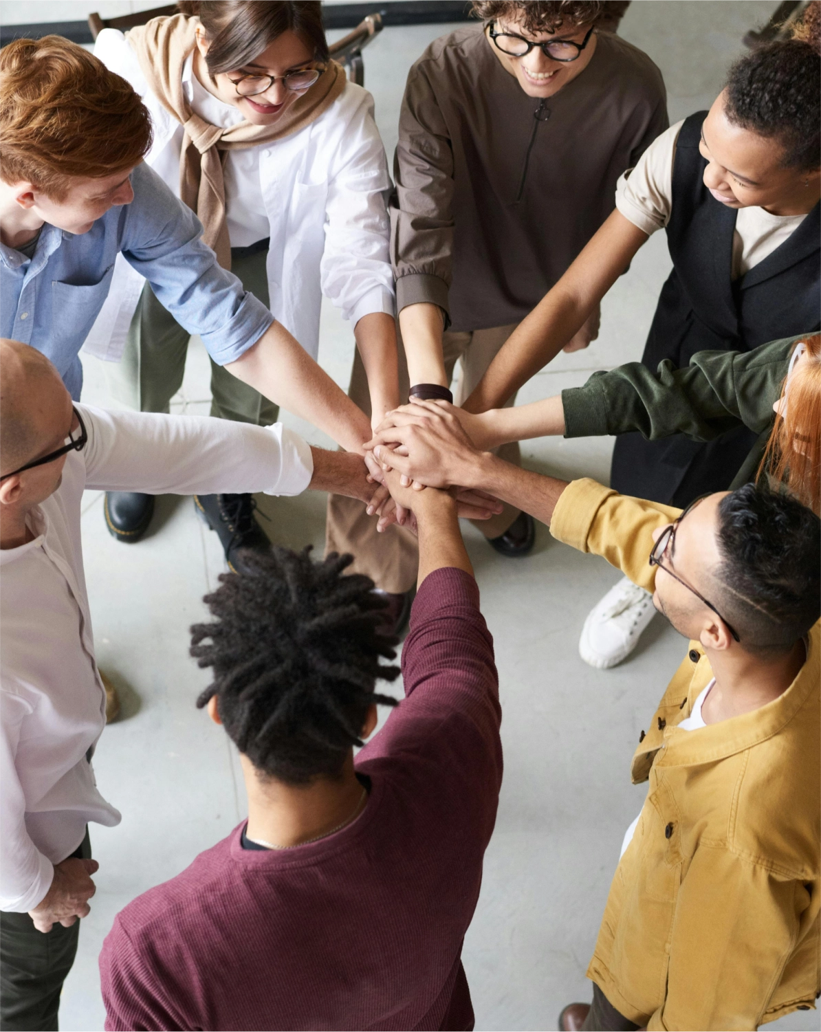 people forming a team by joining hands
